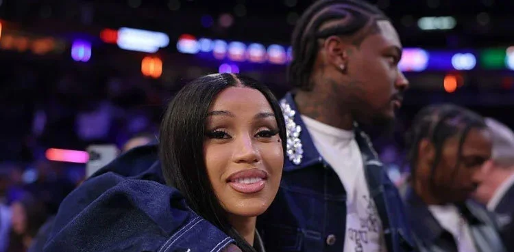Cardi B sitting pose with Stefon Diggs in an event