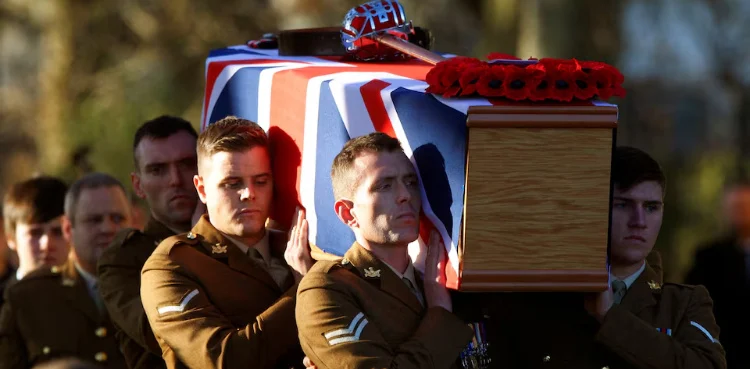UK soldiers carrying the body of a martyr soldier