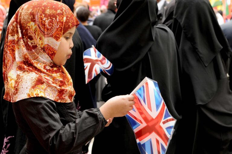 a girl carrying UK flag