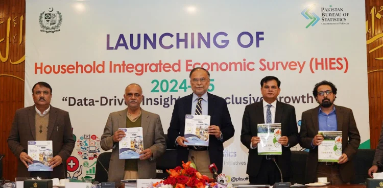 Ahsan iqbal along with others sitting on stage in an event