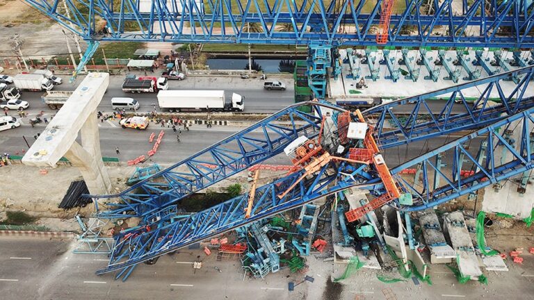 A distroyed crane in middle of road
