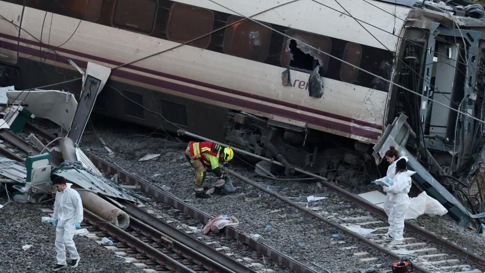 A mechanic inspecting the tracks of derailed train