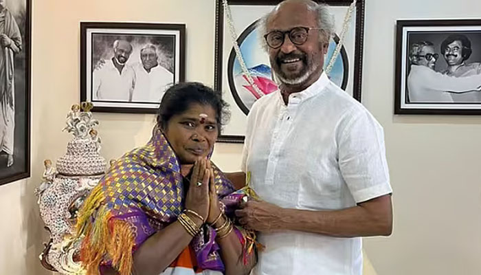 India film star Rajinikanth standing with female cleaner